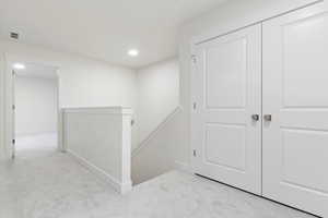 Hallway with light colored carpet