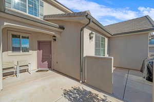 Doorway to property featuring a patio