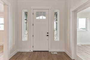 Entryway with light hardwood / wood-style floors