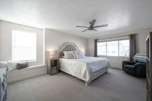 Carpeted bedroom featuring ceiling fan