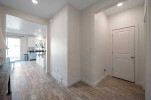 Corridor with light hardwood / wood-style flooring