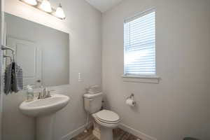 Bathroom featuring hardwood / wood-style floors and toilet