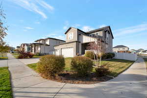 View of front of house with a garage and a front lawn