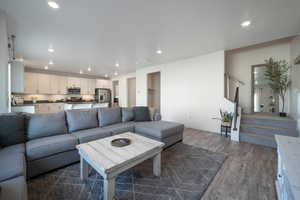 Living room with dark wood-type flooring