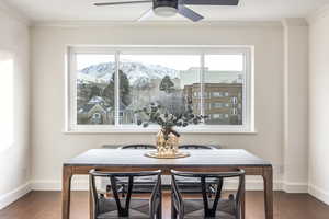 Dining room featuring ceiling fan, crown molding, and a mountain view