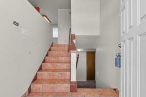 Stairs featuring tile patterned flooring