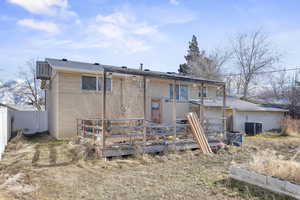 Rear view of house featuring central AC