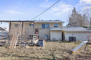 Back of property featuring central AC