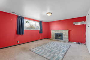 Unfurnished living room with a fireplace and light colored carpet