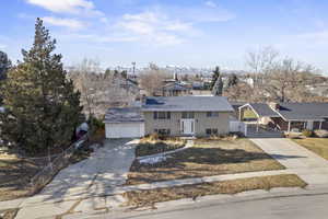 View of front of property with a carport, a mountain view, and a garage