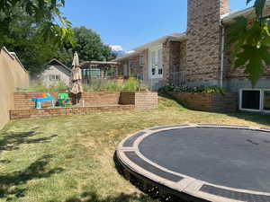 View of yard featuring french doors and a trampoline