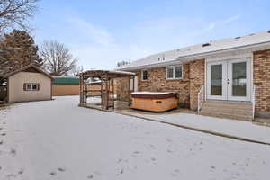 Backyard patio with hot tub, gazebo and shed