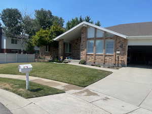 View of front of home featuring a front yard and a garage