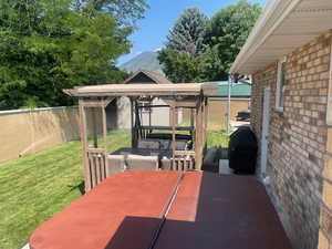 View of patio with a grill and a mountain view