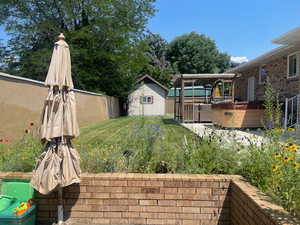 View of yard featuring a shed and a hot tub