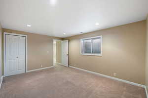 Bedroom 4 featuring light colored carpet and a closet