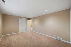 Bedroom 4 featuring light carpet