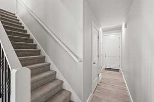 Stairs with hardwood / wood-style flooring