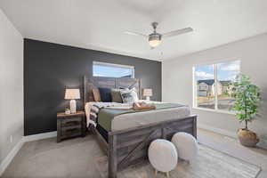 Carpeted bedroom with ceiling fan