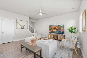 Living room featuring light hardwood / wood-style floors and ceiling fan