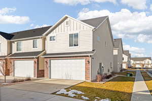 View of front of house featuring a front yard and a garage