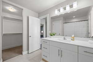 Bathroom featuring vanity and a shower with shower curtain