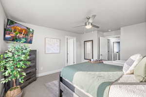 Bedroom featuring light carpet and ceiling fan