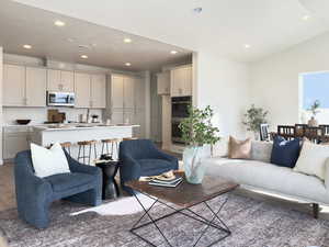 Living room with vaulted ceiling and hardwood / wood-style floors