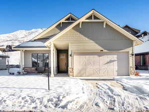 Craftsman house featuring a mountain view and a garage