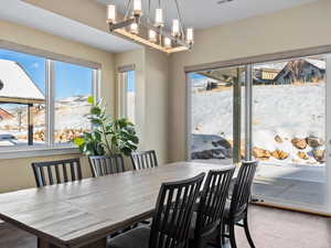 Dining room featuring a wealth of natural light and an inviting chandelier