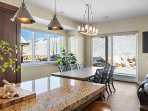 Dining room featuring a healthy amount of sunlight and a notable chandelier