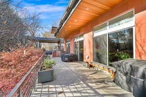 View of patio / terrace with area for grilling and a balcony