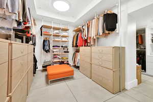 Walk in closet featuring a raised ceiling