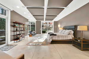Bedroom featuring beam ceiling, multiple windows, and coffered ceiling