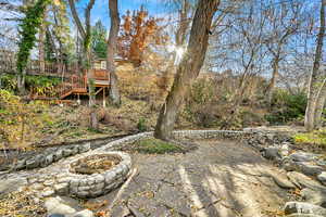 View of patio / terrace with a wooden deck and a fire pit