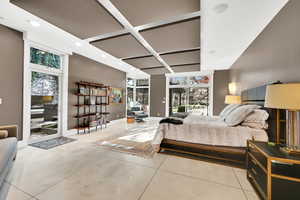 Bedroom featuring tile patterned flooring and coffered ceiling