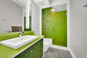 Bathroom with tile patterned floors, vanity, and toilet