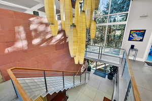 Staircase with tile patterned flooring and plenty of natural light
