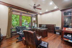 Office area featuring ceiling fan, ornamental molding, and dark wood-type flooring