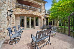 View of patio / terrace featuring french doors, a balcony, and ceiling fan