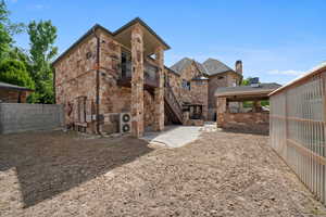 Back of house with a balcony