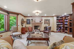 Living room with a fireplace and crown molding