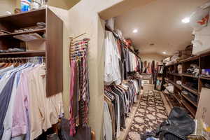 Walk in closet featuring vaulted ceiling