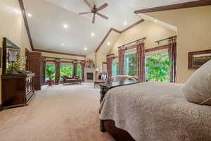 Bedroom featuring light colored carpet, high vaulted ceiling, ceiling fan, and crown molding