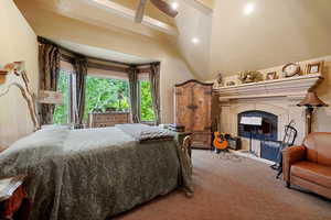 Bedroom featuring beam ceiling, light colored carpet, high vaulted ceiling, and ceiling fan