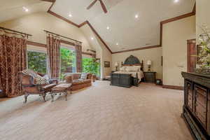 Bedroom featuring ceiling fan, high vaulted ceiling, and light colored carpet