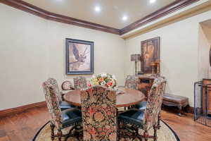 Dining room with light wood-type flooring and ornamental molding