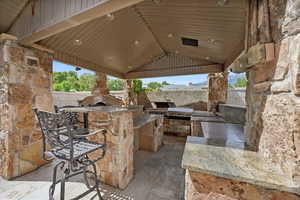 View of patio / terrace featuring a gazebo, a grill, and exterior kitchen