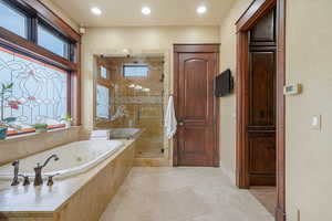 Bathroom featuring plenty of natural light and separate shower and tub