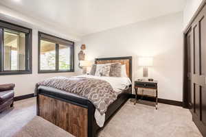 Bedroom featuring a closet and light colored carpet